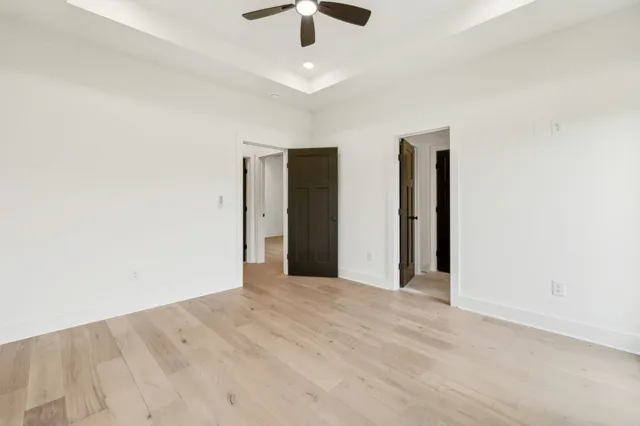 an empty room with fan and windows