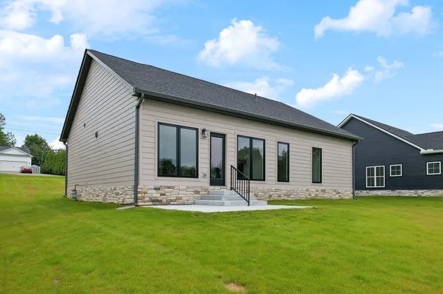 a front view of house with yard and green space