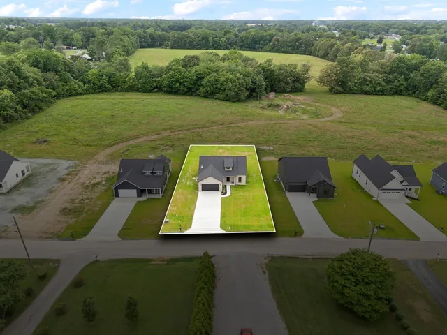 an aerial view of a house with a yard