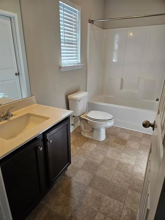 7373 Ledgestone Lane Riverdale, GA 30274 - Photo 12 of 13 a bathroom with a sink a toilet and shower