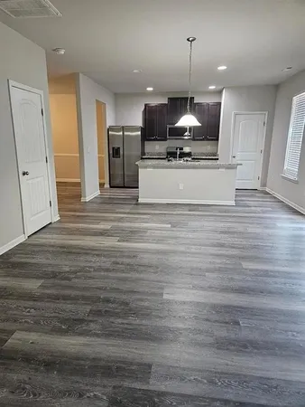 a view of a kitchen with microwave and cabinets