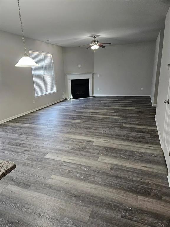 7373 Ledgestone Lane Riverdale, GA 30274 - Photo 4 of 13 a view of an empty room with wooden floor and fan