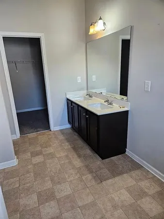 a bathroom with a sink vanity and mirror