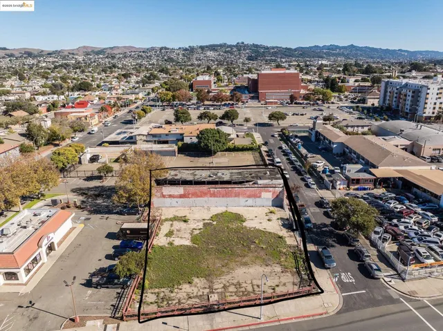 an aerial view of a residential houses with city view