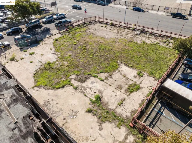 a view of a yard with wooden fence