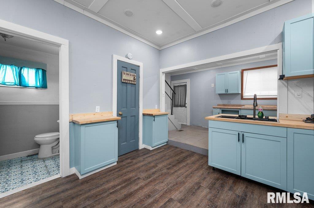 210 North 5th Street Clinton, IA 52732 - Photo 13 of 35 a kitchen with a sink and a stove