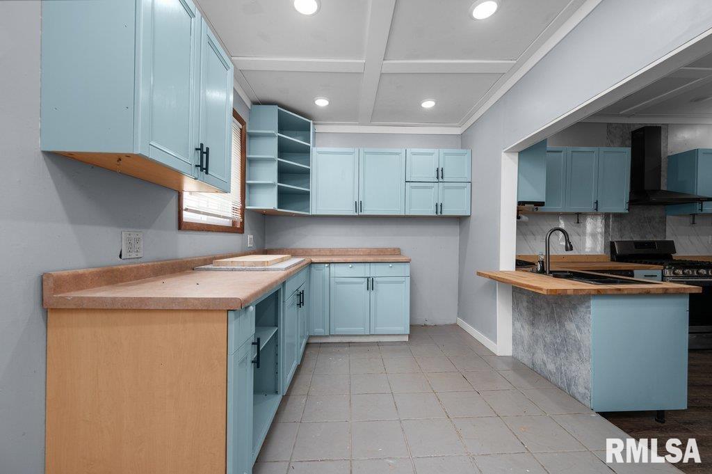 210 North 5th Street Clinton, IA 52732 - Photo 16 of 35 a kitchen with a sink stove and cabinets