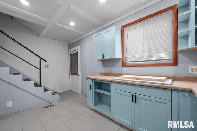 a view of cabinets with window and wooden floor