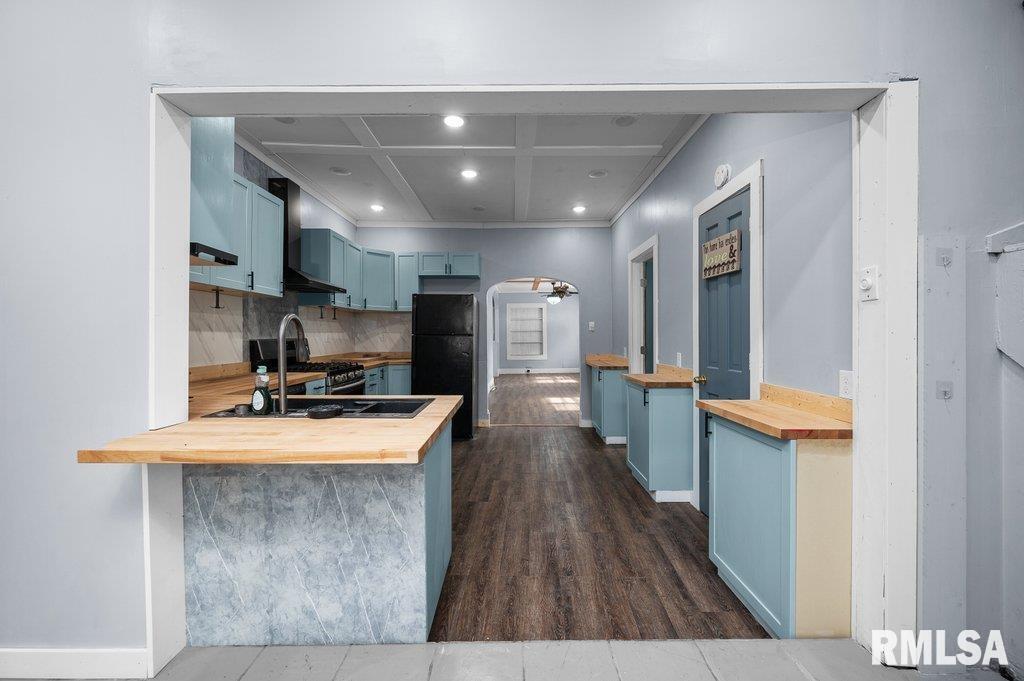 210 North 5th Street Clinton, IA 52732 - Photo 18 of 35 a room with stainless steel appliances a kitchen island a sink a refrigerator and a view of living room