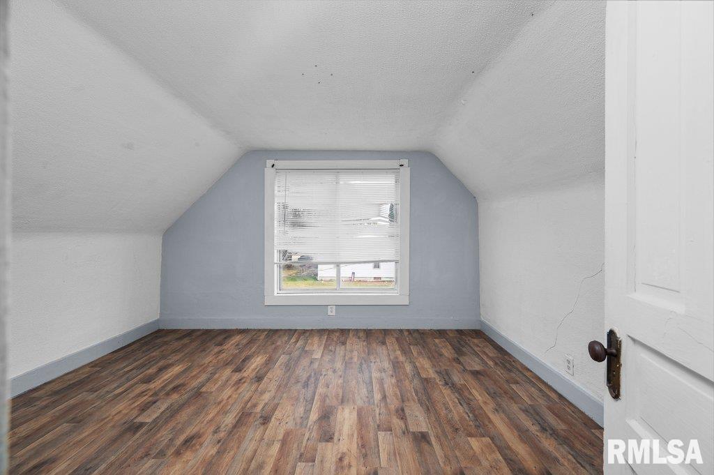 210 North 5th Street Clinton, IA 52732 - Photo 21 of 35 a view of an empty room with wooden floor and a window