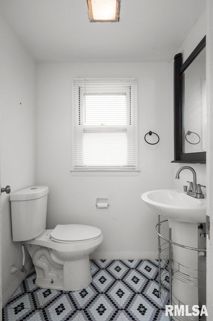 210 North 5th Street Clinton, IA 52732 - Photo 24 of 35 a bathroom with a sink toilet and a mirror