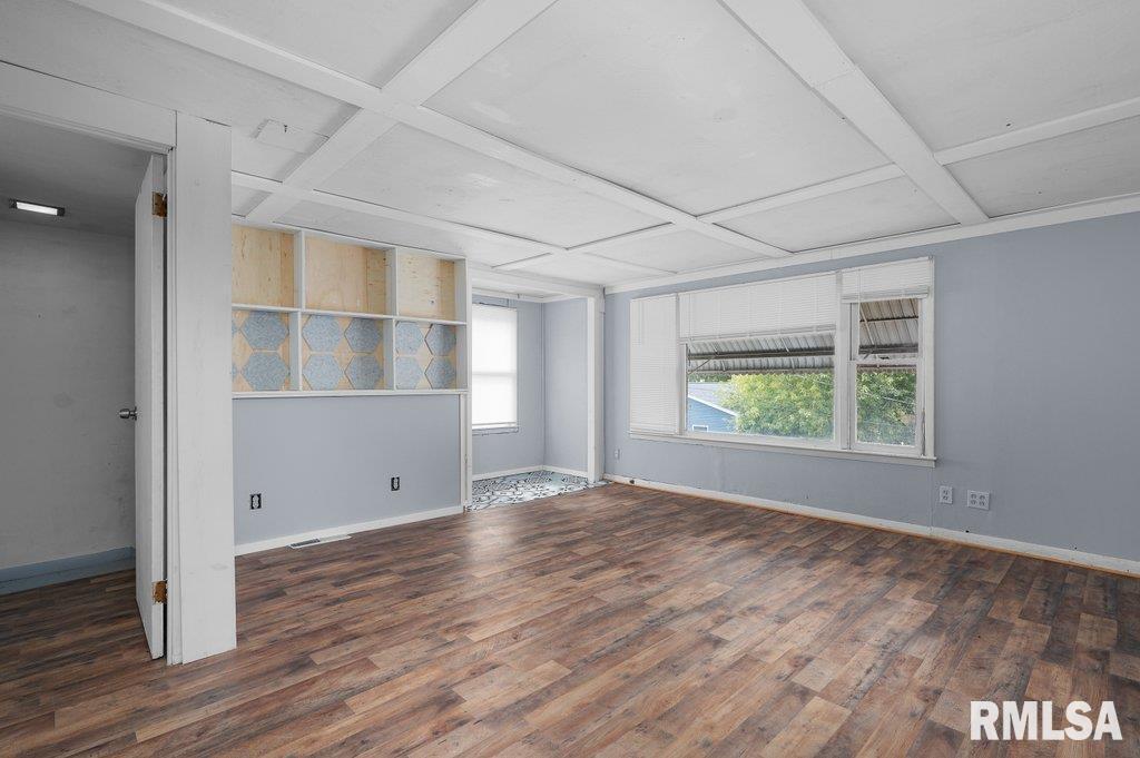 210 North 5th Street Clinton, IA 52732 - Photo 25 of 35 a view of an empty room with wooden floor and a window