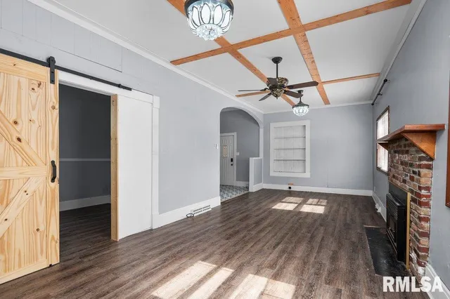 a view of a livingroom with wooden floor and a ceiling fan