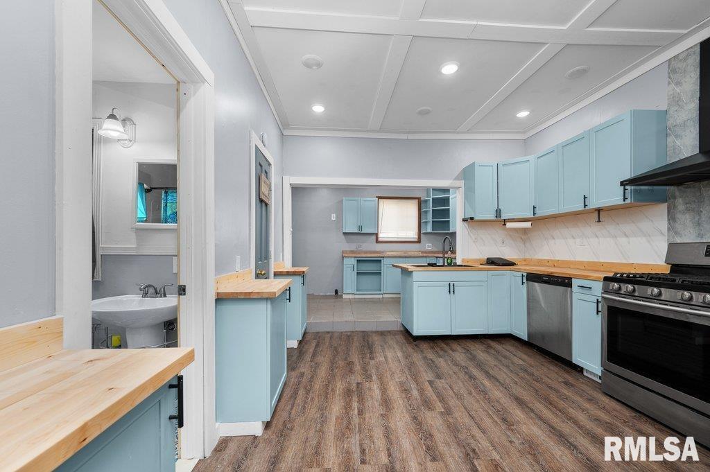 210 North 5th Street Clinton, IA 52732 - Photo 10 of 35 a kitchen that has a lot of cabinets a sink and appliances in it