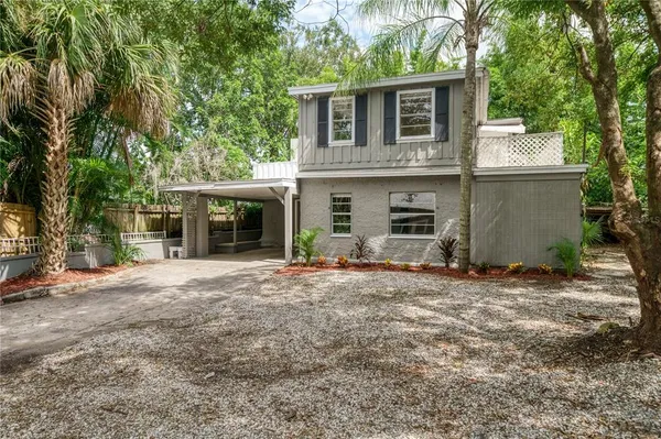 a front view of a house with a yard and a garage