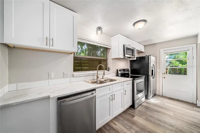 a kitchen with a sink stove and refrigerator
