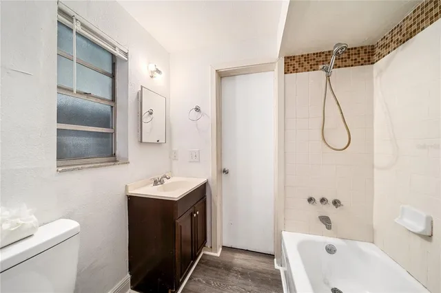 a bathroom with a sink vanity mirror and toilet