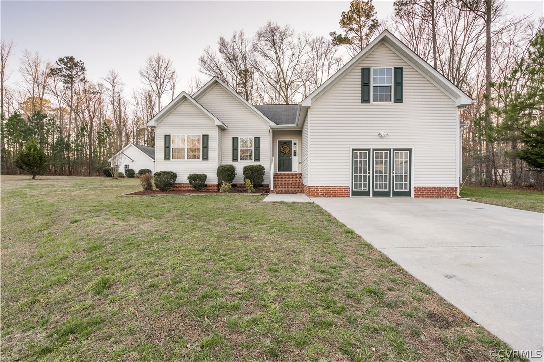 14613 Clover Ridge Lane Chesterfield, VA 23832 - Photo 1 of 36 a view of a white house with a yard and large trees