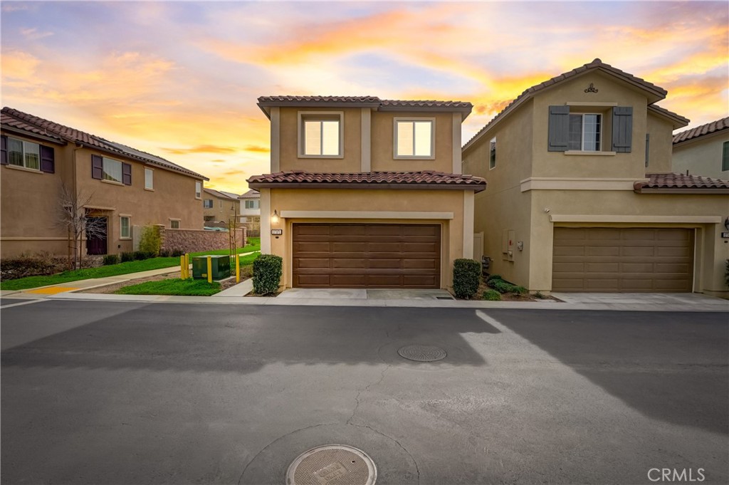 27371 Red Rock Road Moreno Valley, CA 92555 - Photo 1 of 1 a front view of a house with a yard and garage