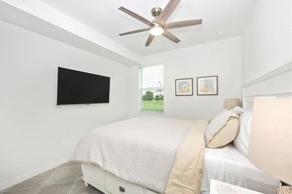 a front view of a house with glass windows and furniture