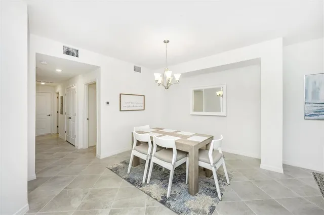 a living room with furniture a flat screen tv and a window