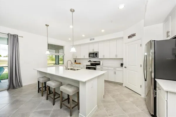 a kitchen with white cabinets and white appliances