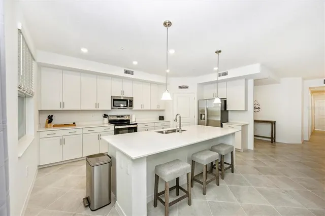 a kitchen with a sink stove and cabinets