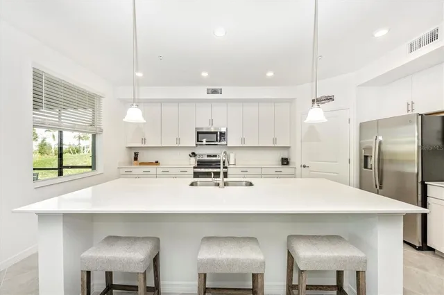 a kitchen with a sink a stove and refrigerator
