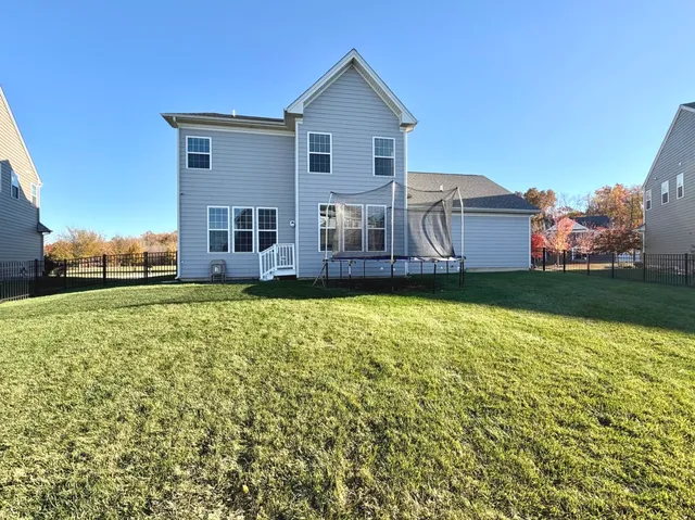 a front view of a house with a yard and trees