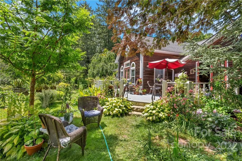 528 Padgettown Road Black Mountain, NC 28711 - Photo 22 of 37 a view of a patio with table and chairs potted plants and large tree