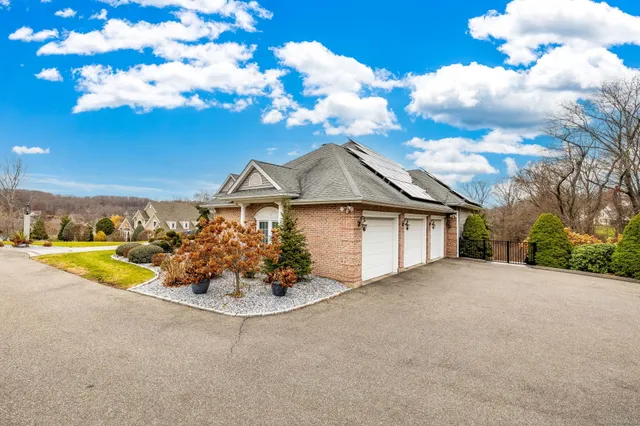 a view of a house with a yard and garage