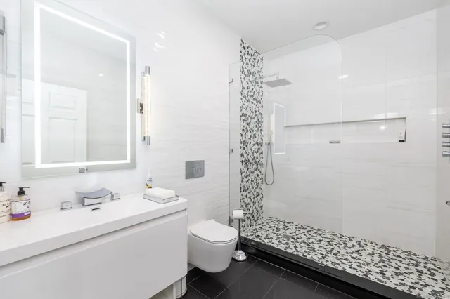 a bathroom with a sink toilet and shower