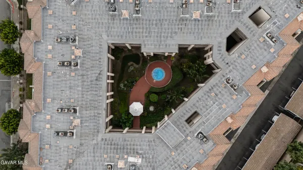an empty room with wooden floor a fireplace and windows