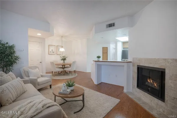a living room with furniture and a fireplace