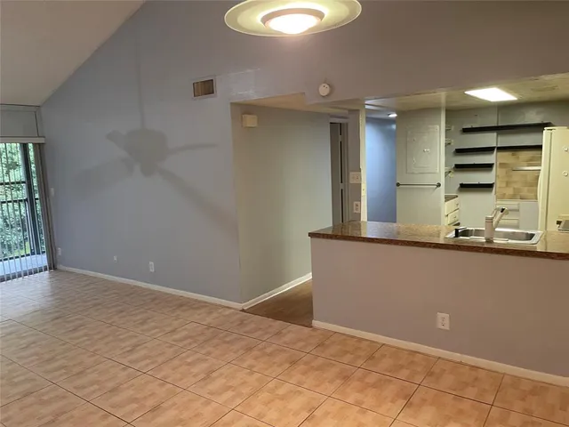 a kitchen with granite countertop a stove and a sink