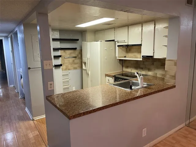 a kitchen with a stove microwave and refrigerator