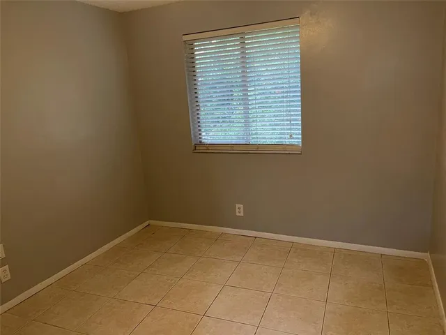a view of a room with wooden floor and a floor to ceiling window