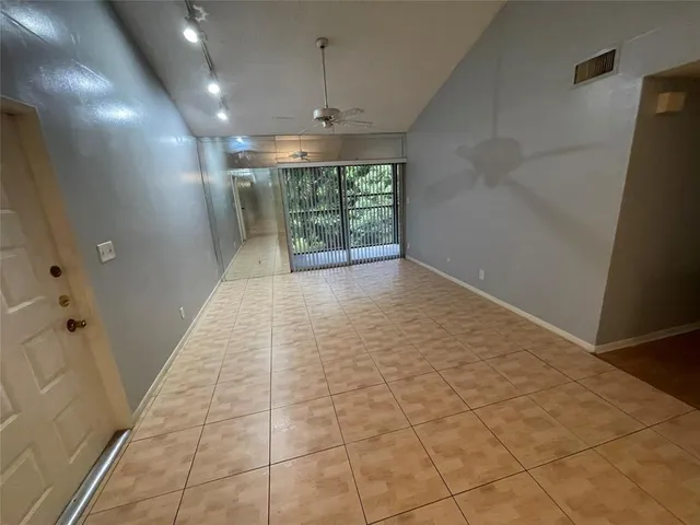 a view of an empty room with a chandelier