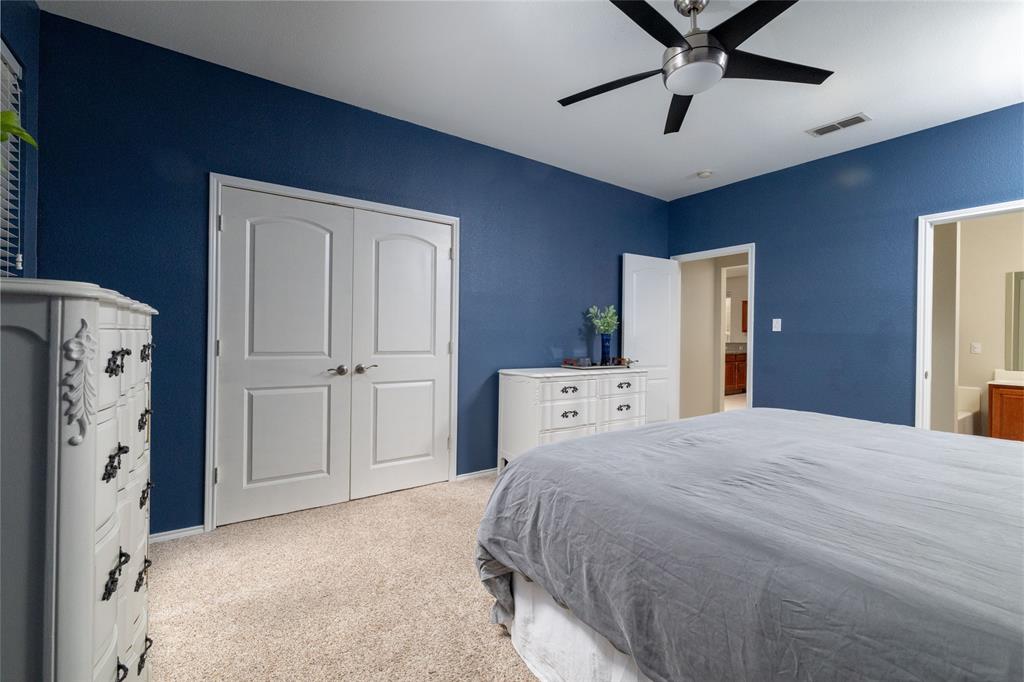 4025 Chisos Rim Trail Fort Worth, TX 76244 - Photo 21 of 40 Carpeted bedroom featuring a ceiling fan, white baseboards, and dual arched panel doors