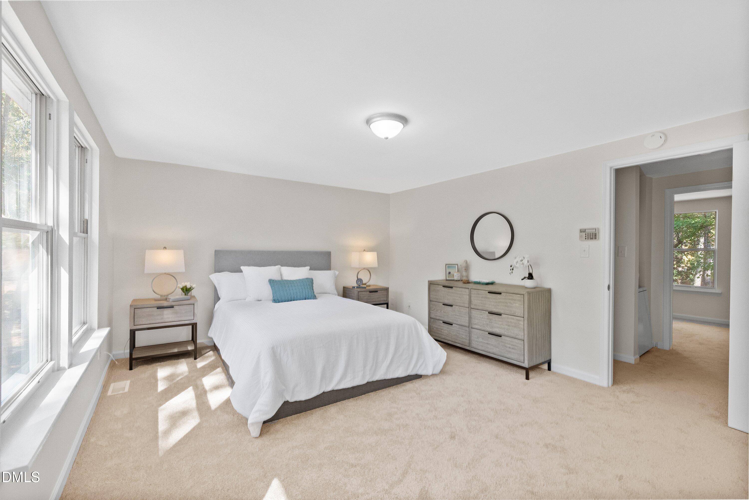 632 Middleton Avenue Cary, NC 27513 - Photo 22 of 34 a bedroom with a bed and a chandelier