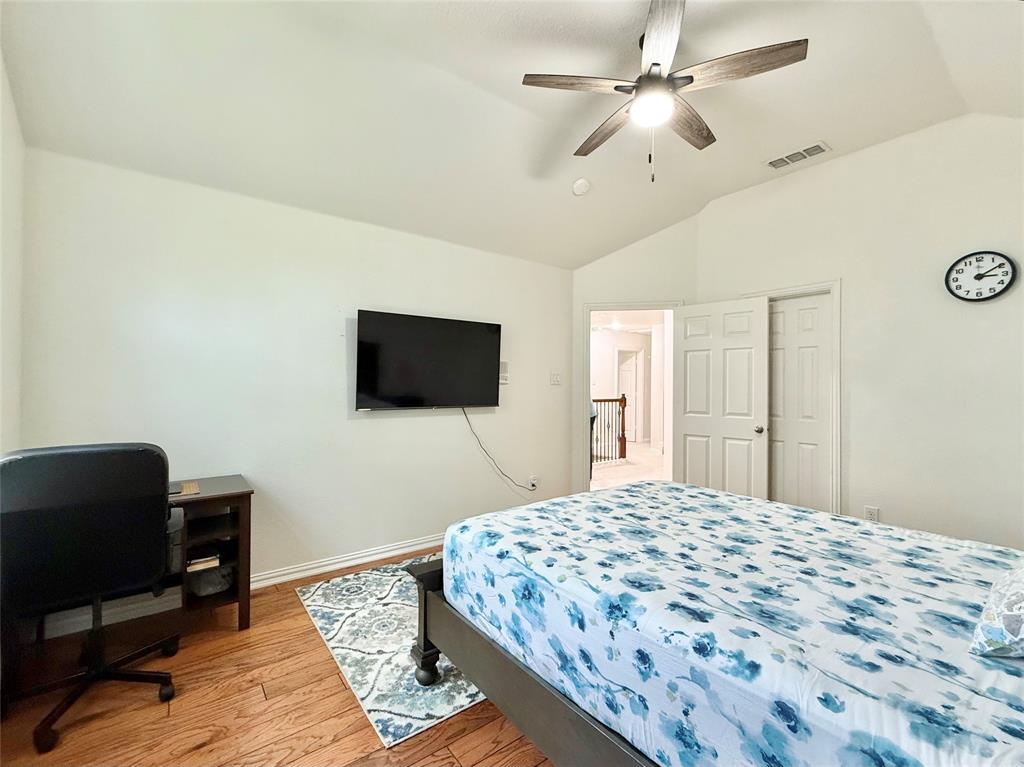 2754 Ridge View Road Frisco, TX 75034 - Photo 20 of 34 a bedroom with a bed and a flat screen tv