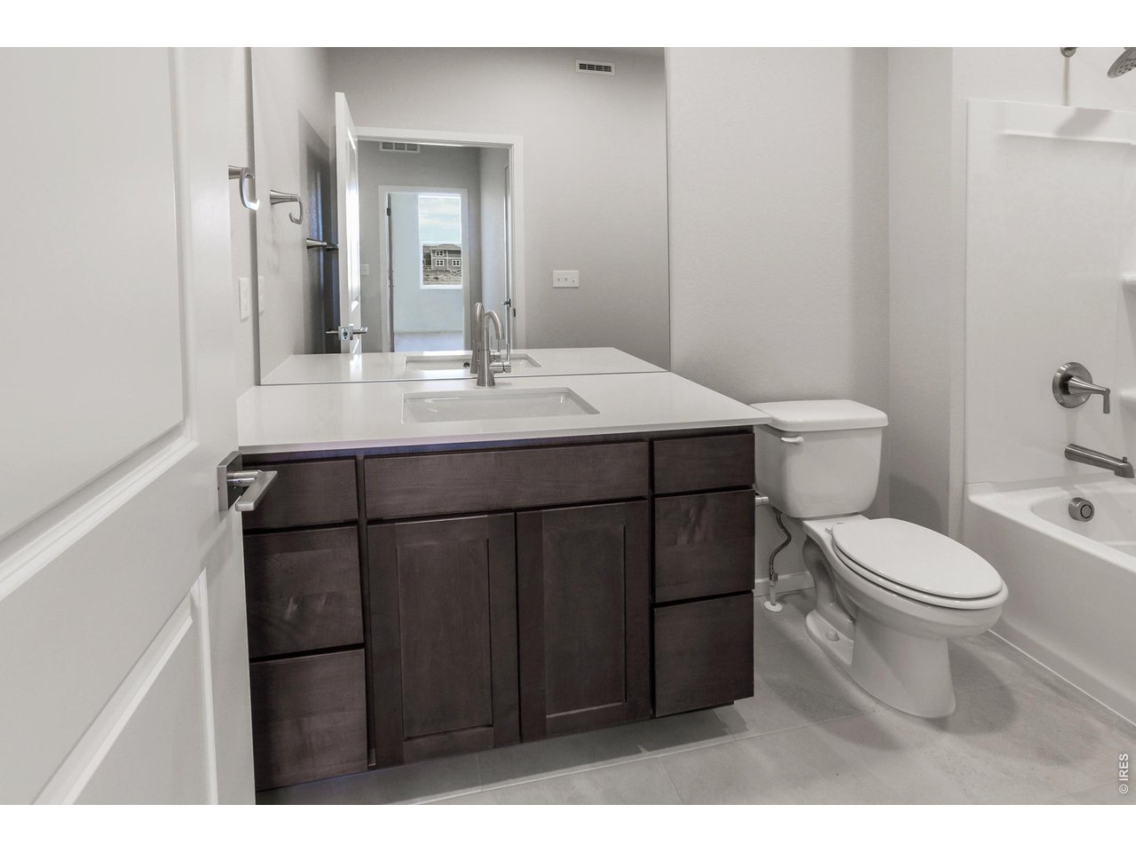 792 Chatter Road Windsor, CO 80550 - Photo 7 of 49 a bathroom with a sink a toilet a mirror and shower