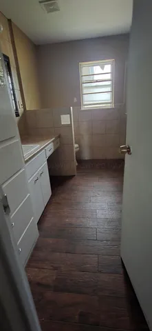 a view of storage and utility room with wooden floor