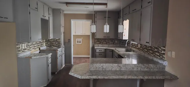 a kitchen with a sink stove and refrigerator