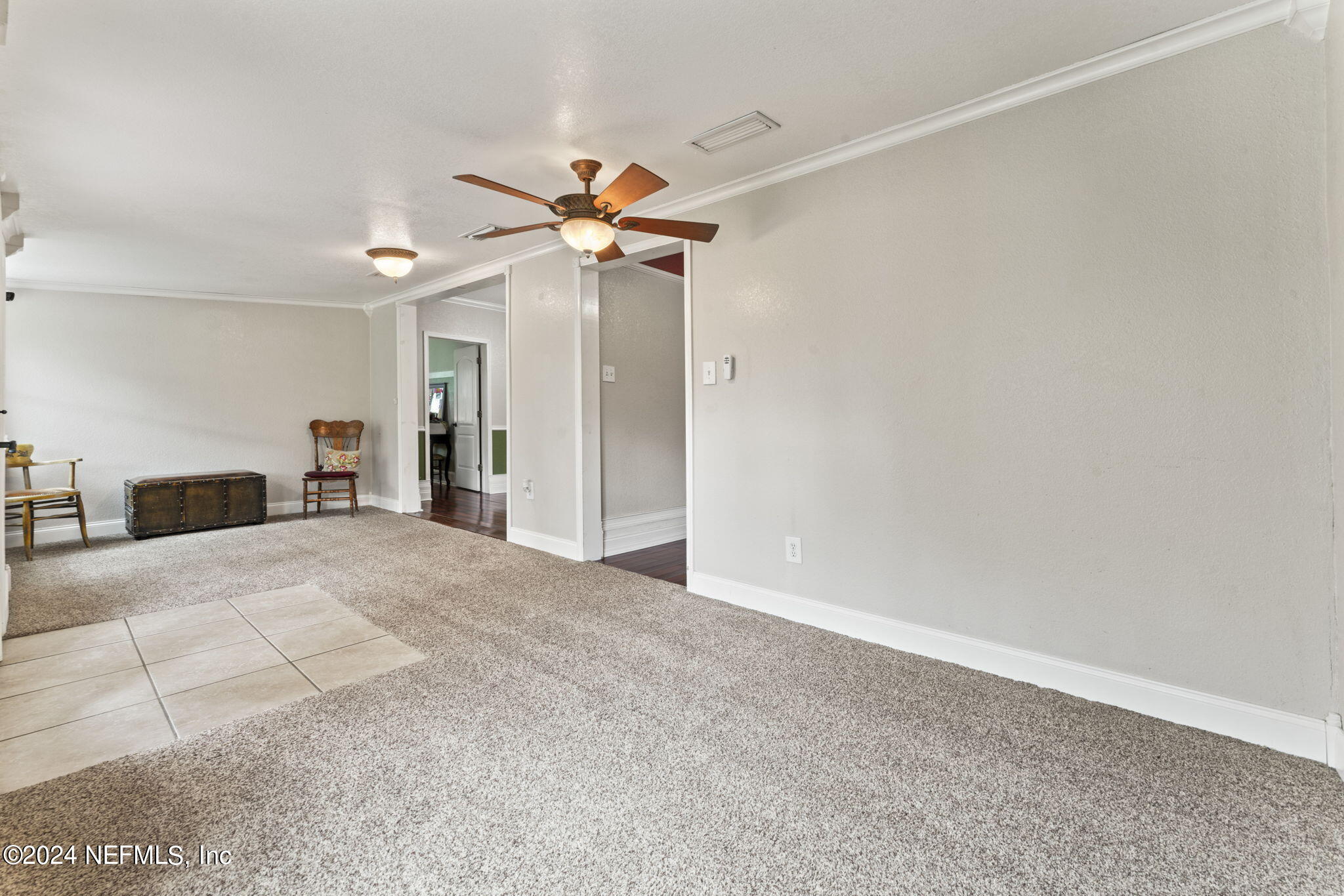 542284 Lem Turner Road Callahan, FL 32011 - Photo 16 of 84 a view of a bedroom with a ceiling fan and a bathroom
