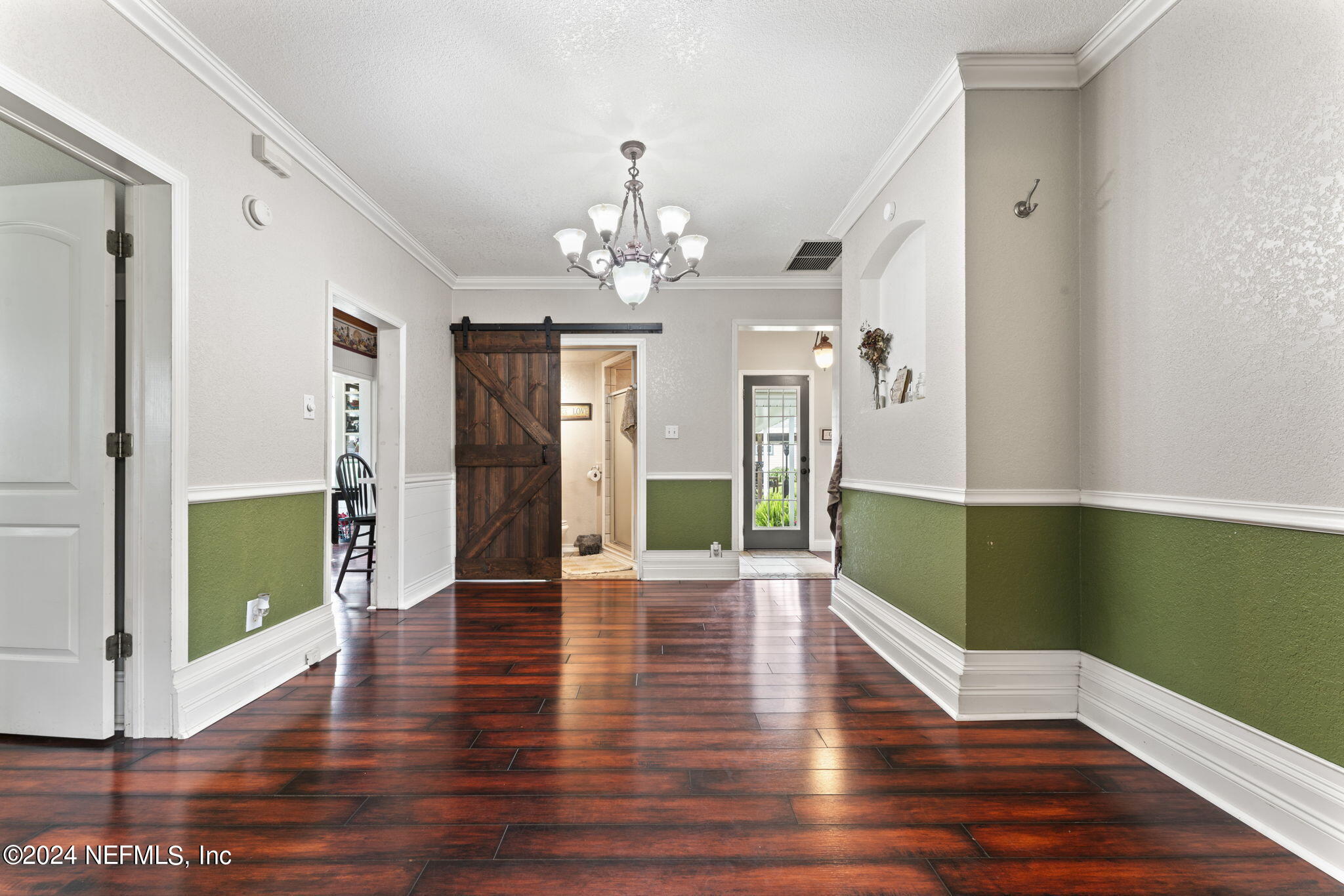 542284 Lem Turner Road Callahan, FL 32011 - Photo 18 of 84 a view of a hallway with wooden floor and a chandelier