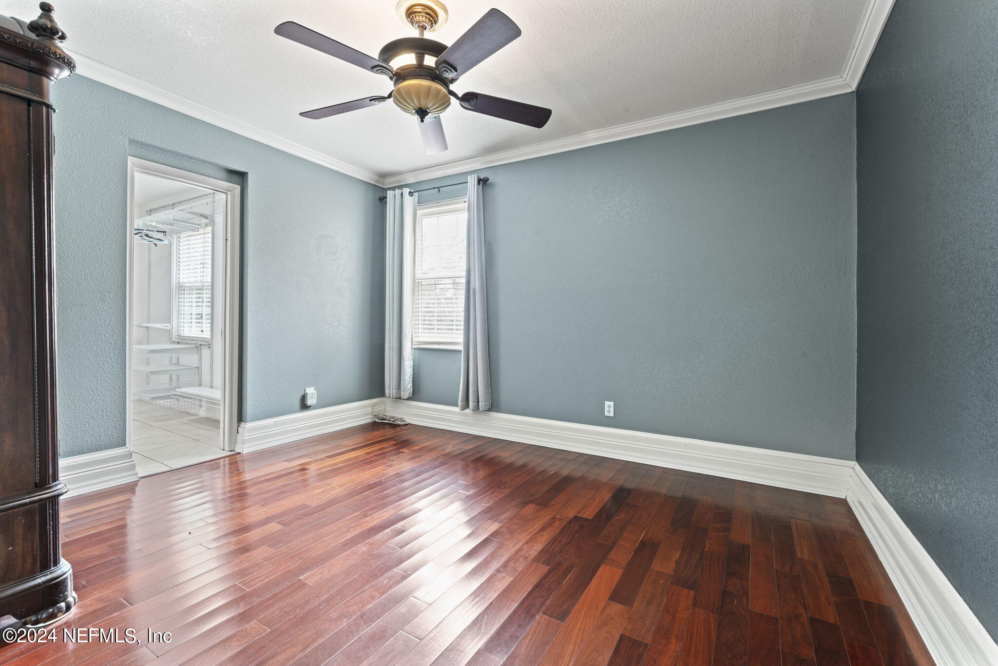 542284 Lem Turner Road Callahan, FL 32011 - Photo 22 of 84 an empty room with wooden floor and windows
