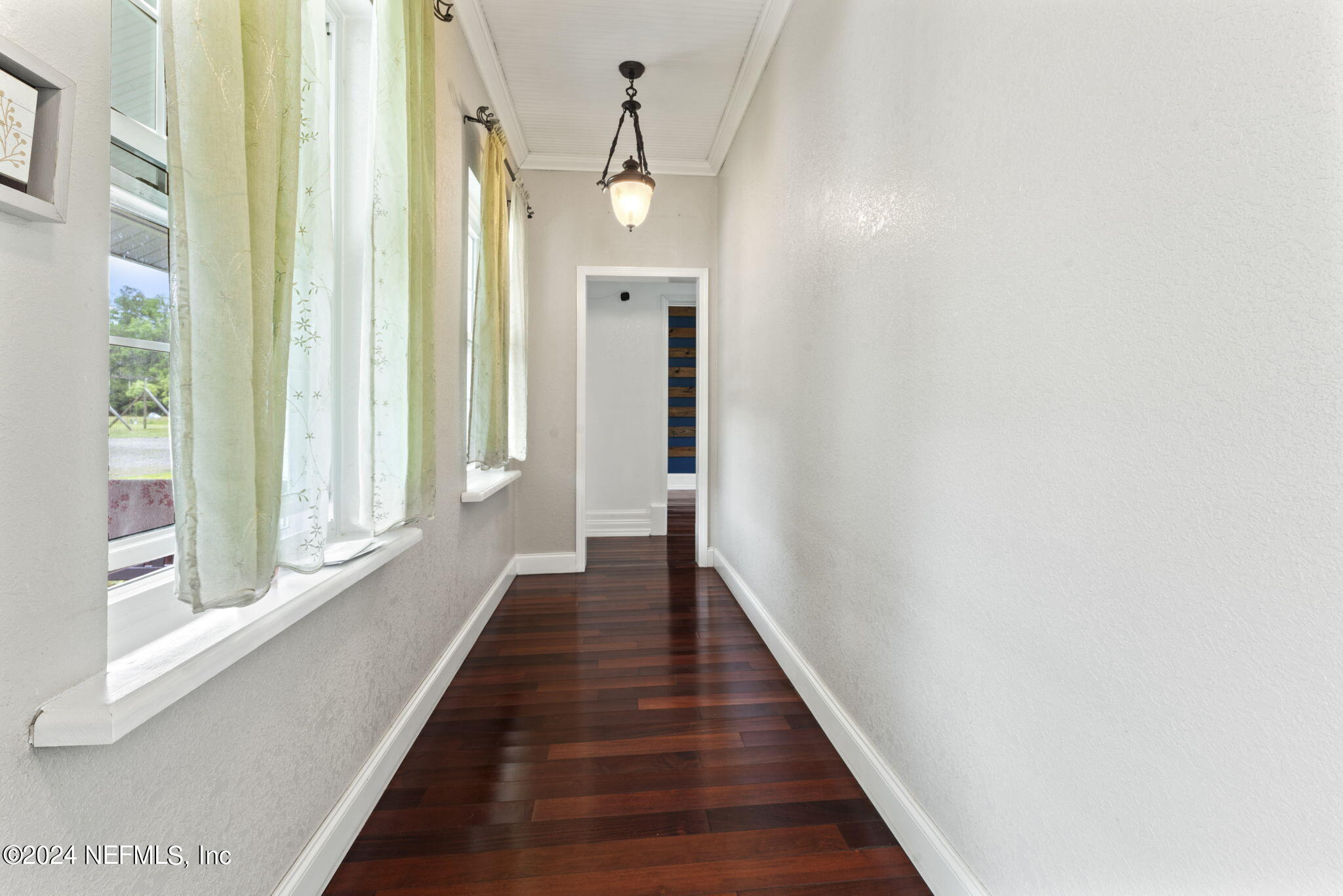 542284 Lem Turner Road Callahan, FL 32011 - Photo 33 of 84 a view of a hallway with wooden floor and staircase