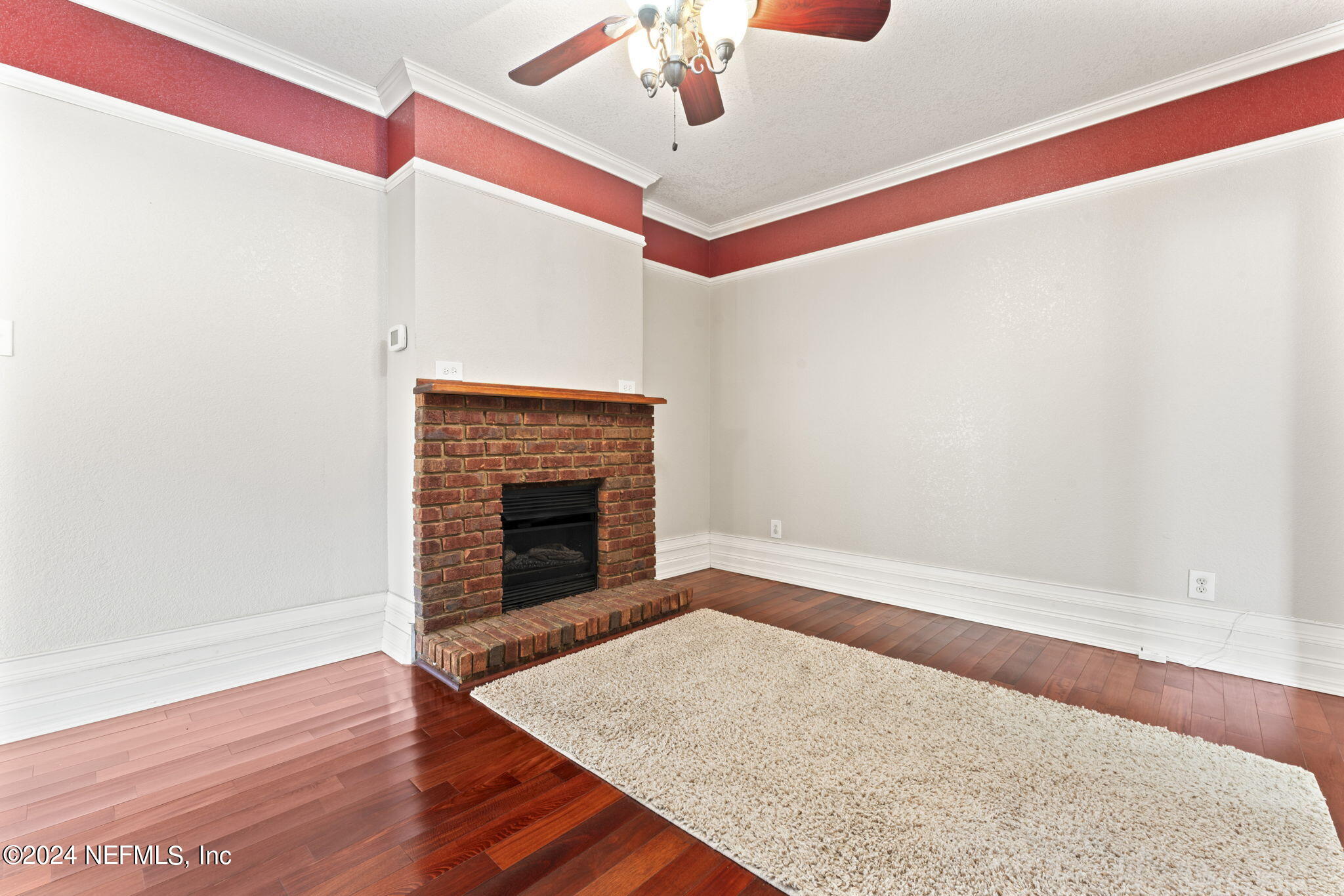 542284 Lem Turner Road Callahan, FL 32011 - Photo 40 of 84 a view of an empty room with wooden floor and a fireplace
