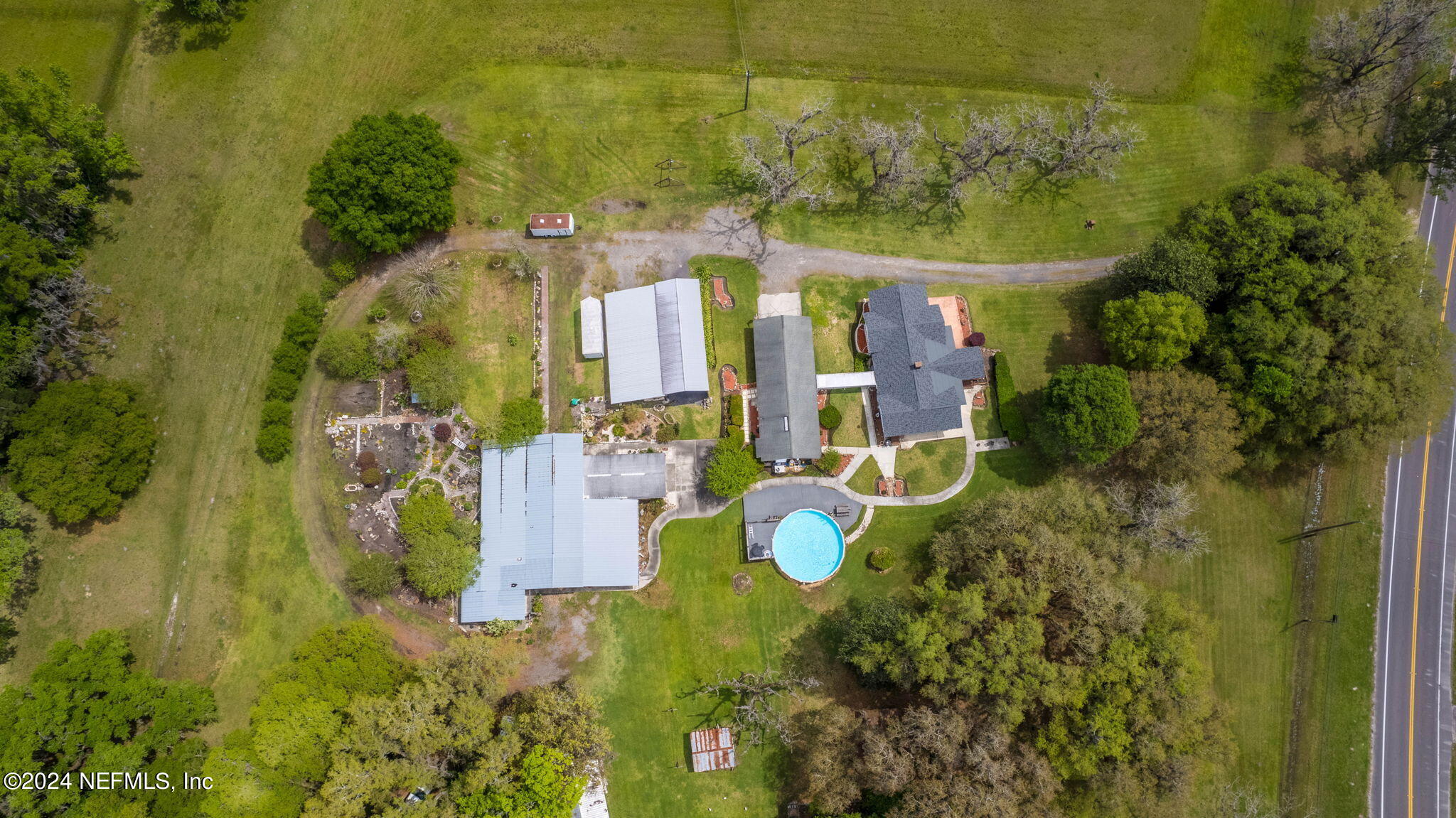 542284 Lem Turner Road Callahan, FL 32011 - Photo 4 of 84 an aerial view of a house with a yard swimming pool and outdoor seating